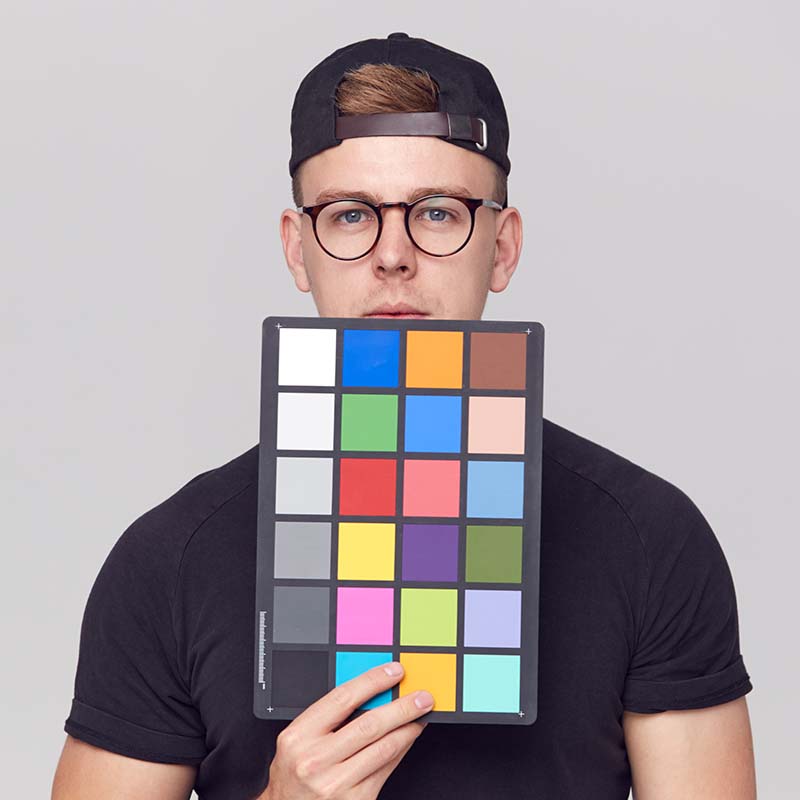 portrait of male photographer in studio holding co CT8YX77